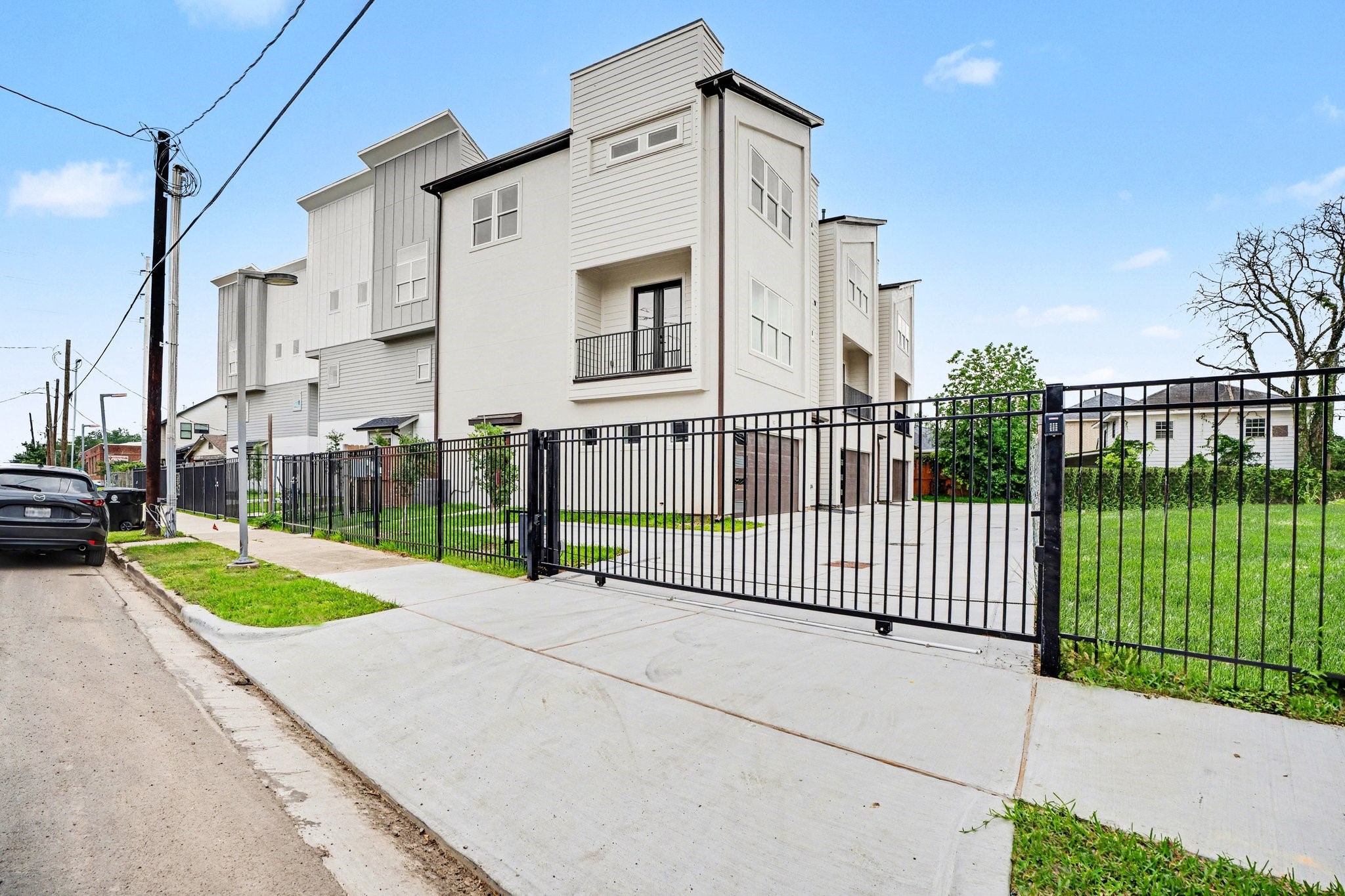 115 Milby Street Houston, TX 77003 - Photo 1 of 28 Modern multi-story townhouse with a sleek exterior, featuring large windows and a gated driveway. Located in a residential area with ample parking offering a blend of urban and suburban living.