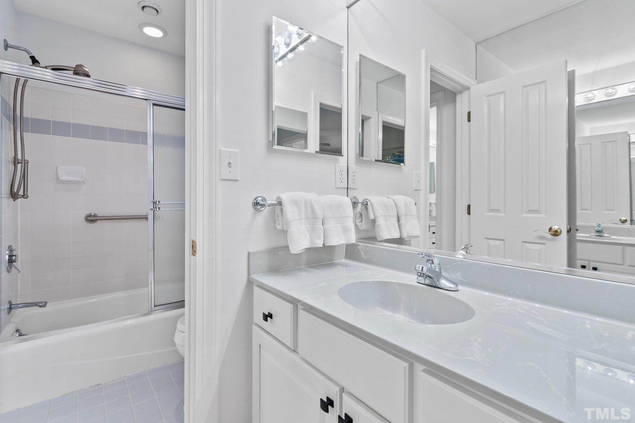 3518 Ridge Road Durham, NC 27705 - Photo 27 of 47 Ceramic walled wet area is shared between the two single vanities.