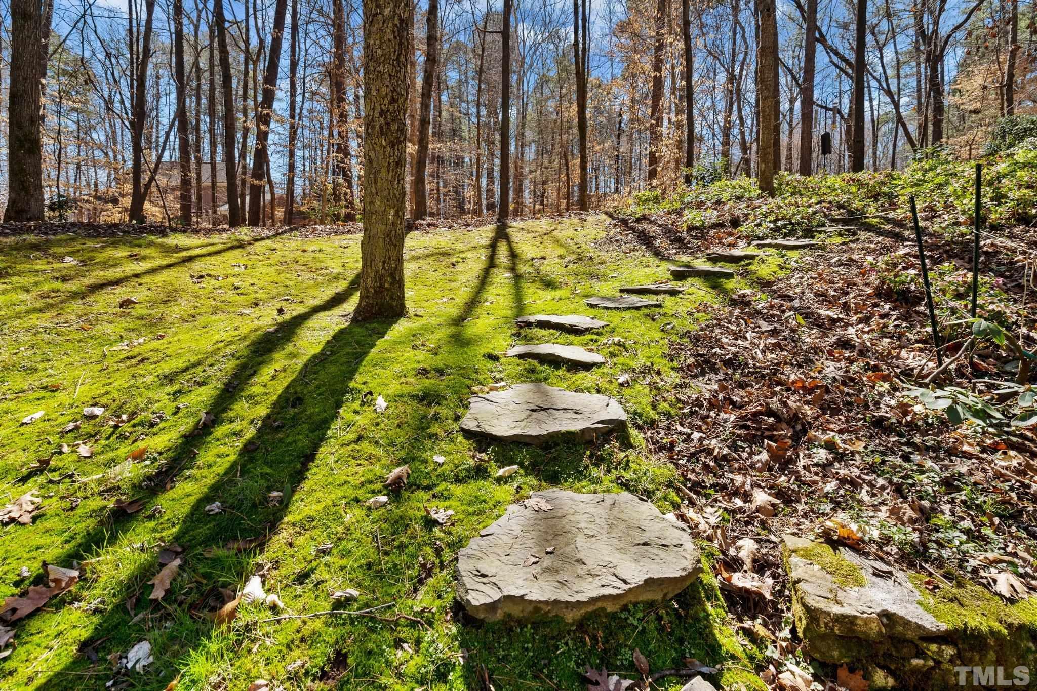 3518 Ridge Road Durham, NC 27705 - Photo 42 of 47 Large stones create a path to the upper yard and deck from the sheltered patio on lower level.