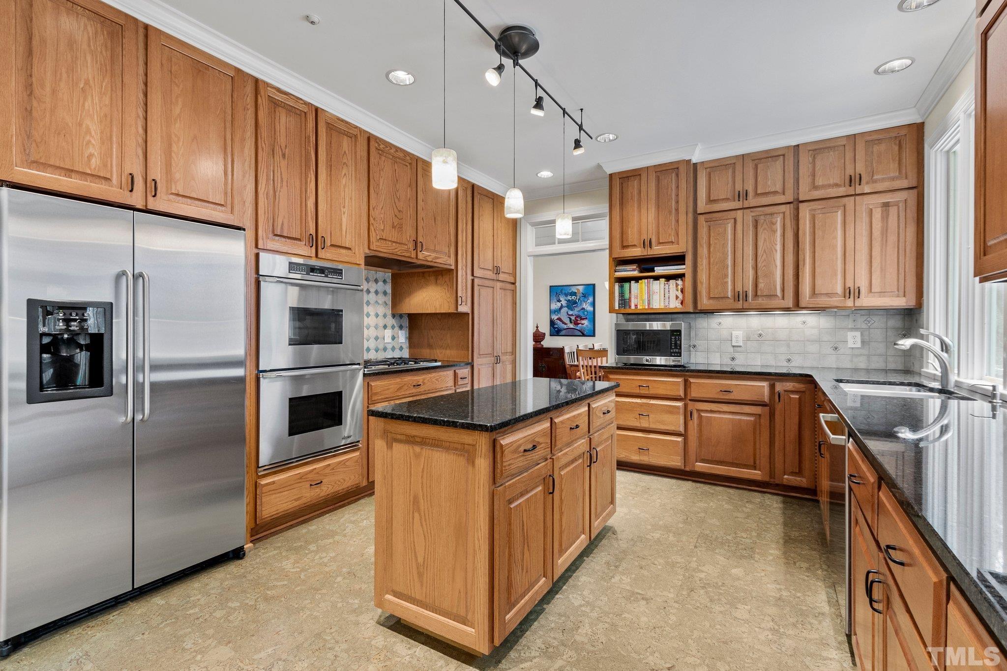 3518 Ridge Road Durham, NC 27705 - Photo 7 of 47 Center island expands work space options. Gas cooktop has pretty tile backsplash.