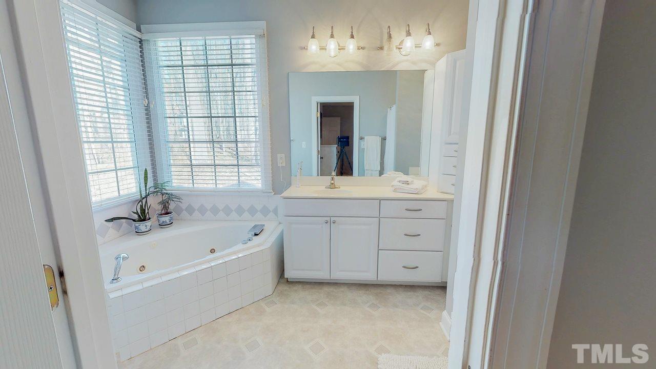 522 Edwin Court Roxboro, NC 27573 - Photo 14 of 24 a bathroom with a tub sink and mirror