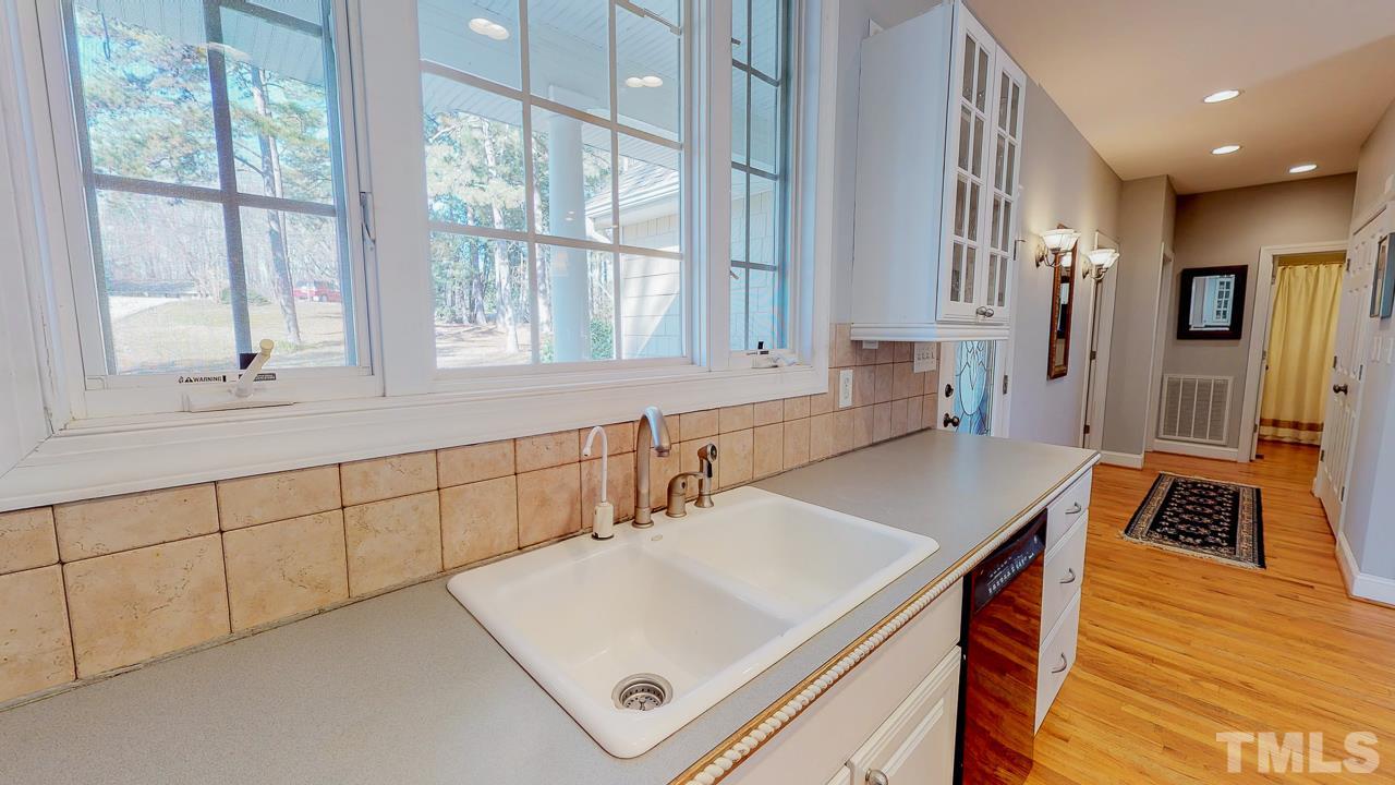 522 Edwin Court Roxboro, NC 27573 - Photo 22 of 24 a kitchen with stainless steel appliances cabinets a stove a sink and a large window