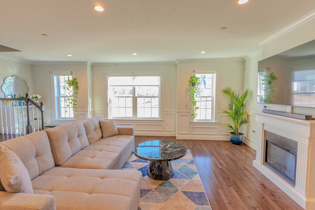 2 Mitchell Lane, Unit B Weymouth, MA 02190 - Photo 11 of 31 a living room with furniture a fireplace and a large window
