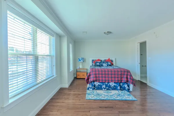 a bedroom with a bed and window
