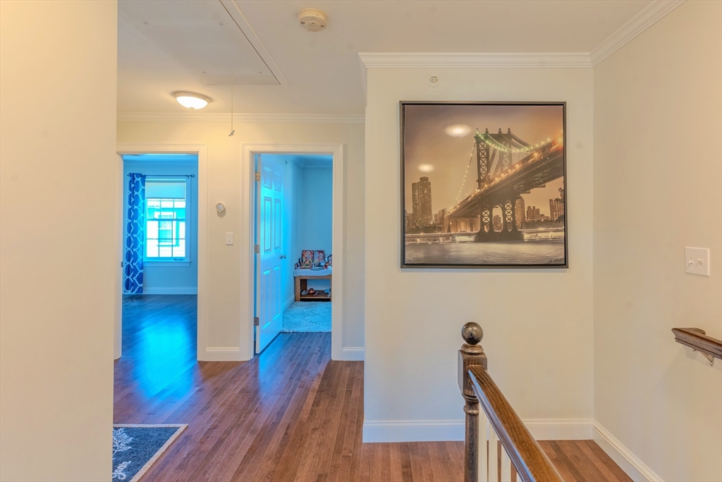 2 Mitchell Lane, Unit B Weymouth, MA 02190 - Photo 17 of 31 a view of a hallway with wooden floor and staircase