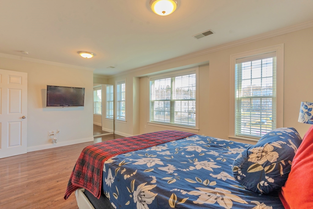 2 Mitchell Lane, Unit B Weymouth, MA 02190 - Photo 18 of 31 a bedroom with a bed and a flat screen tv