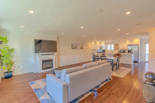 a room with stainless steel appliances kitchen island a table and chairs in it
