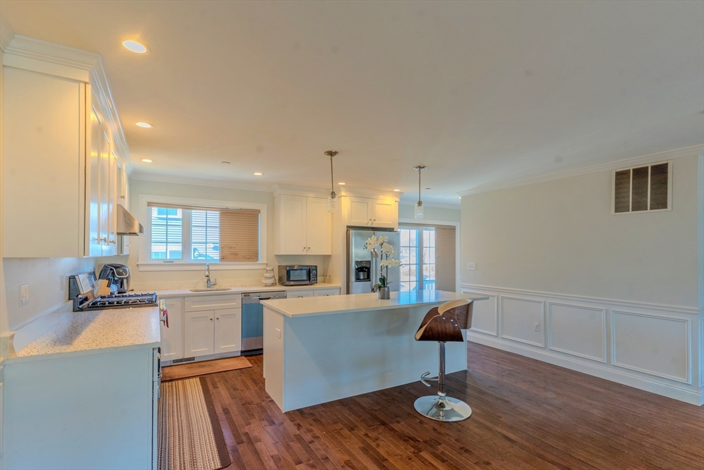 2 Mitchell Lane, Unit B Weymouth, MA 02190 - Photo 21 of 31 a room with stainless steel appliances kitchen island a table and chairs in it