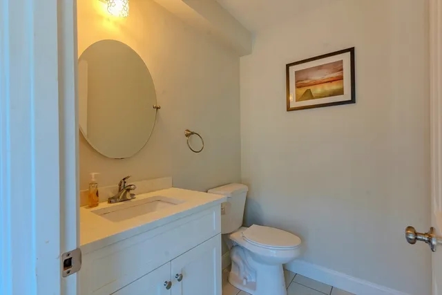 a bathroom with a sink toilet and mirror