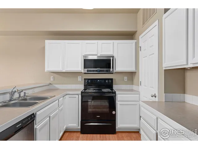 a kitchen with a sink stove and microwave