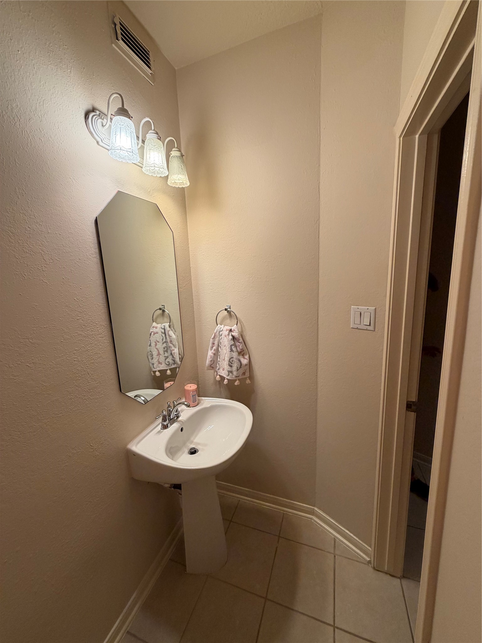 18963 Candlelight Crescent Road Spring, TX 77388 - Photo 24 of 33 Downstairs half bath features a sleek pedestal sink.