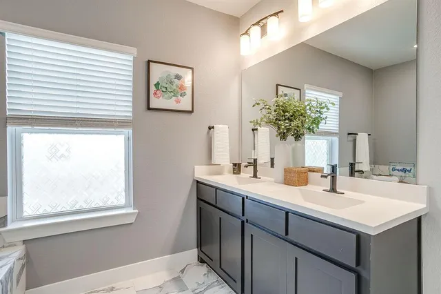 a bathroom with a sink and a mirror
