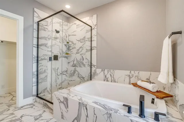 a bathroom with a bathtub and a shower