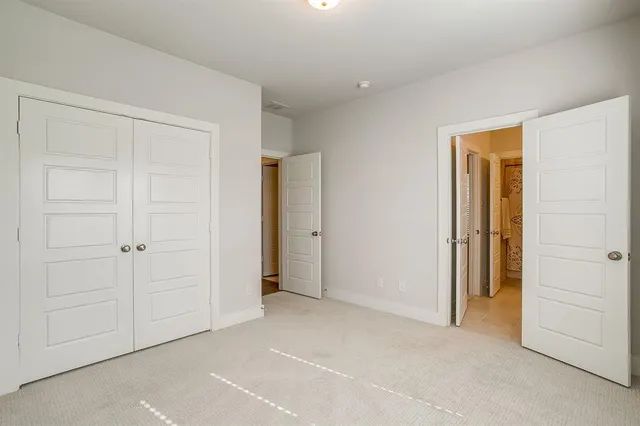 a view of an empty room and closet area
