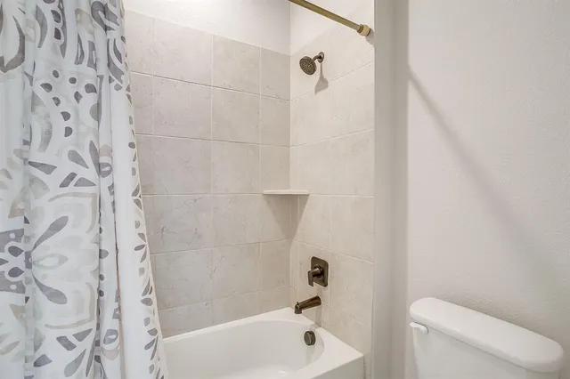 a bathroom with a shower and a toilet