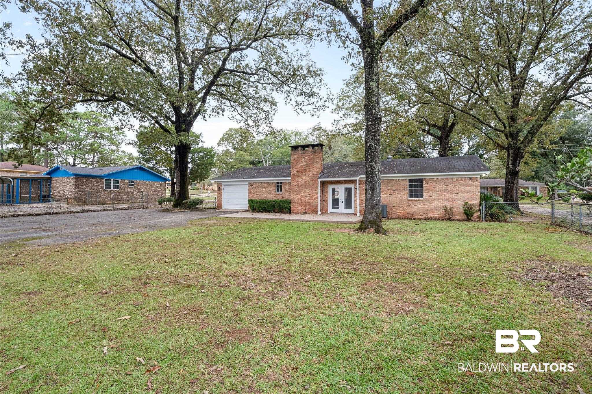 5015 Golfway Drive Eight Mile, AL 36613 - Photo 29 of 31 View of front of property with a front lawn and a garage