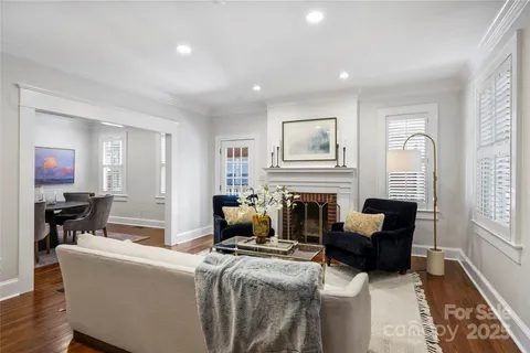 a living room with furniture a fireplace and a window