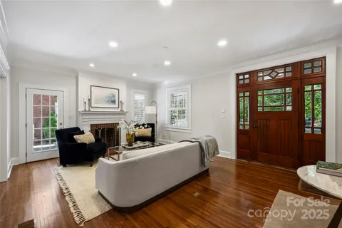 a living room with fireplace furniture and a wooden floor