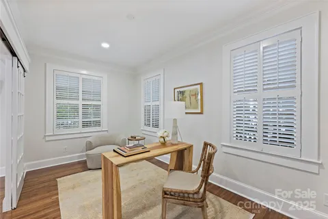 a dining room with furniture and windows