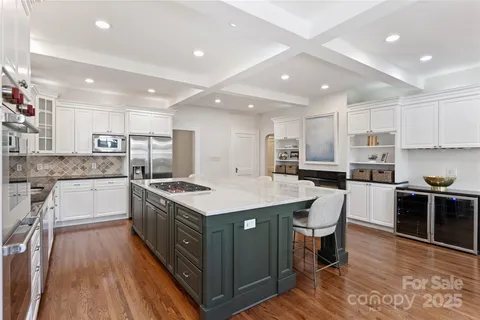 a kitchen with a stove sink and cabinets