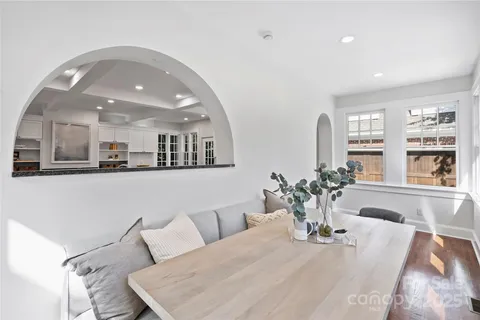 a living room with furniture and view of kitchen