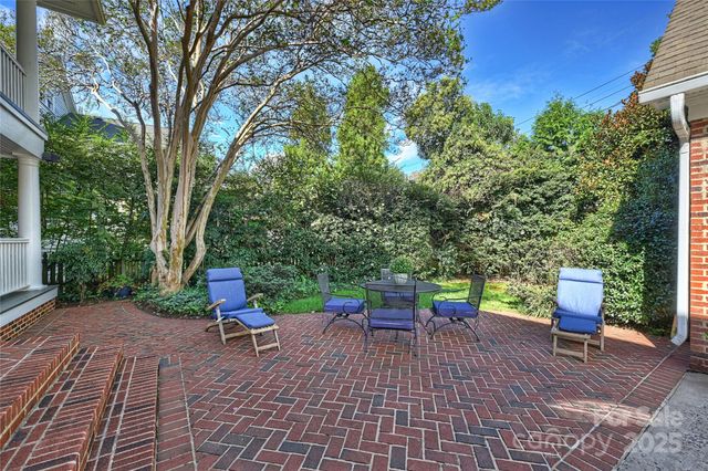 a view of a backyard with sitting area