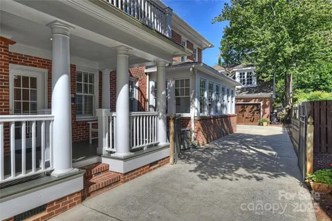 a view of a house with a small yard and wooden fence