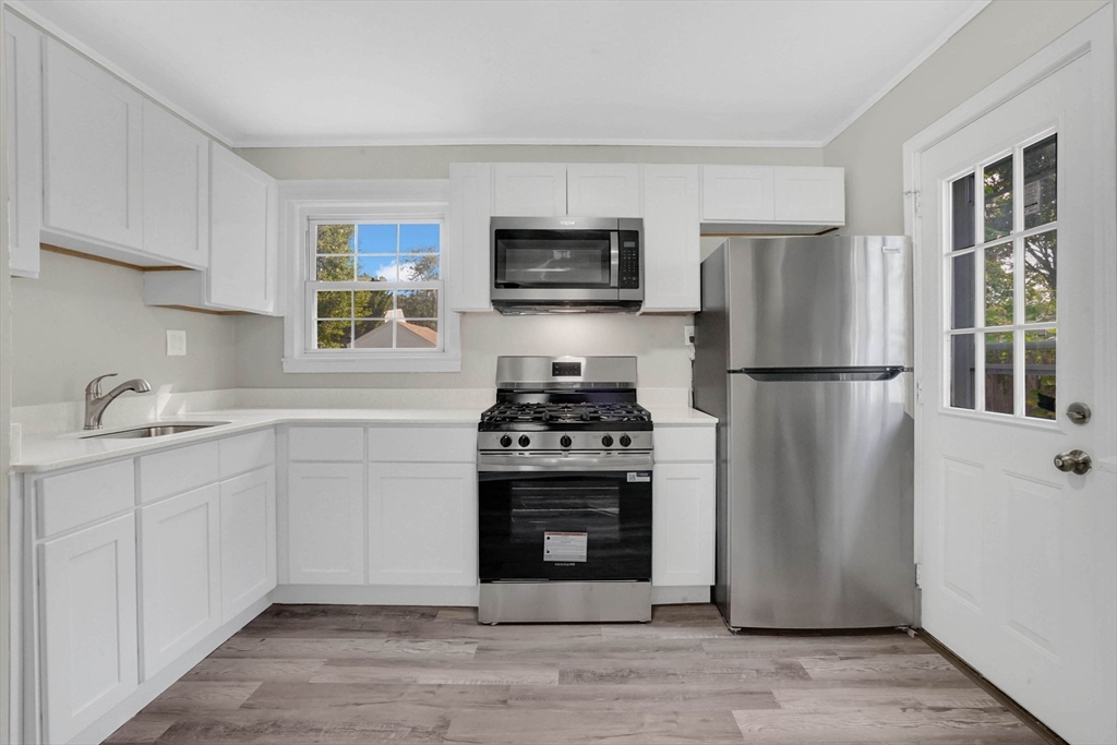 55 Pheland Street Springfield, MA 01109 - Photo 12 of 28 a kitchen with stainless steel appliances a refrigerator stove and sink