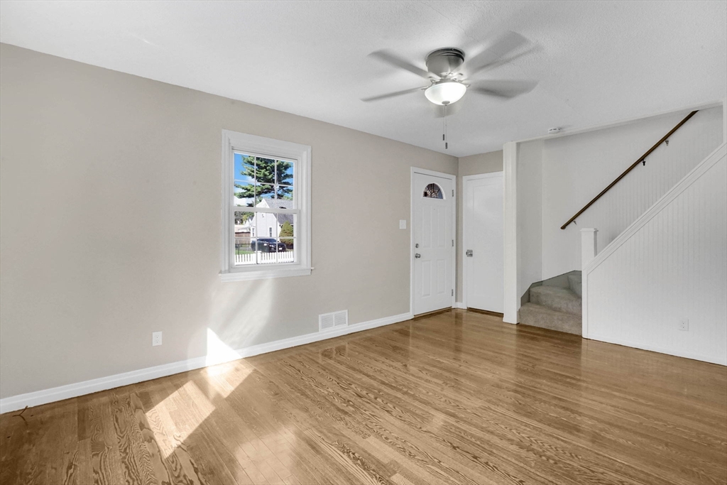 55 Pheland Street Springfield, MA 01109 - Photo 6 of 28 a view of an empty room with window and wooden floor