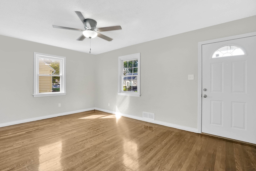 55 Pheland Street Springfield, MA 01109 - Photo 7 of 28 a view of an empty room with wooden floor and a window