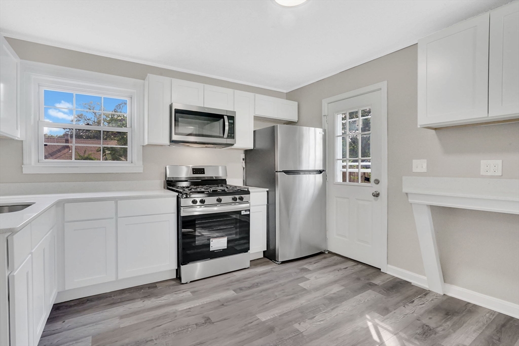 55 Pheland Street Springfield, MA 01109 - Photo 8 of 28 a kitchen with stainless steel appliances a refrigerator stove and microwave
