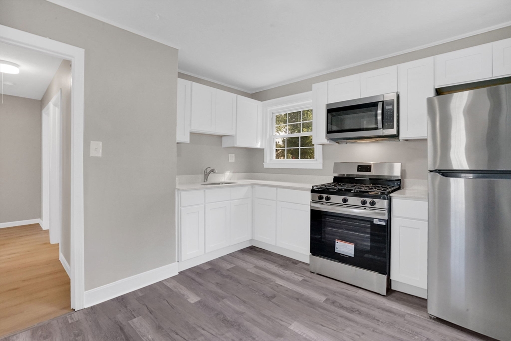 55 Pheland Street Springfield, MA 01109 - Photo 9 of 28 a kitchen with stainless steel appliances a refrigerator stove and microwave