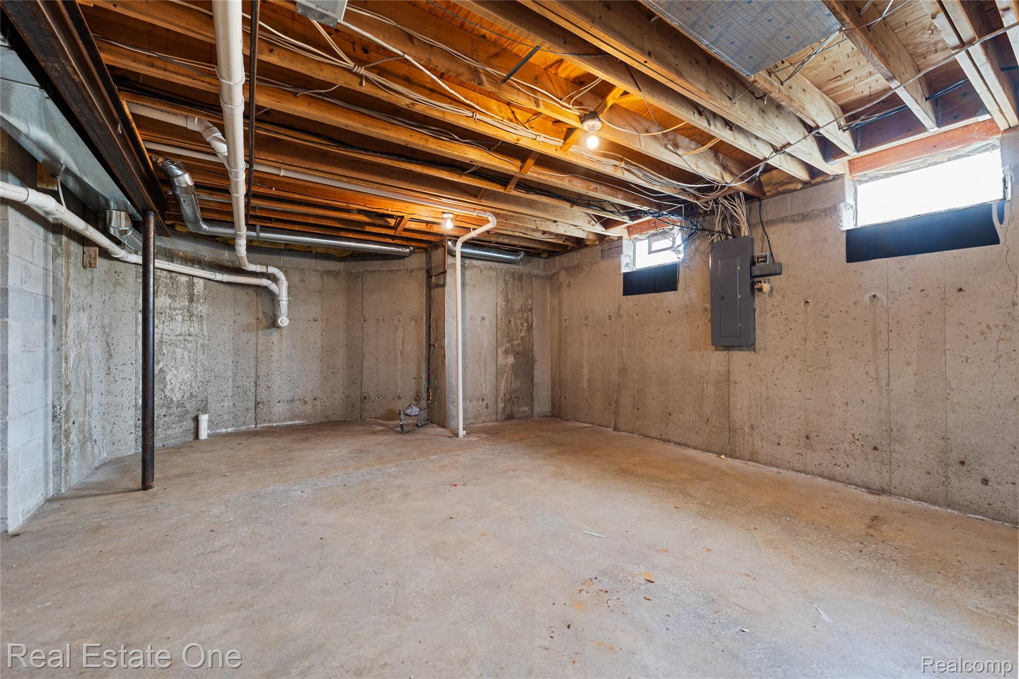 17268 Beech Daly Road Romulus, MI 48174 - Photo 59 of 60 Unfinished concrete basement with exposed wood joists and concrete block walls