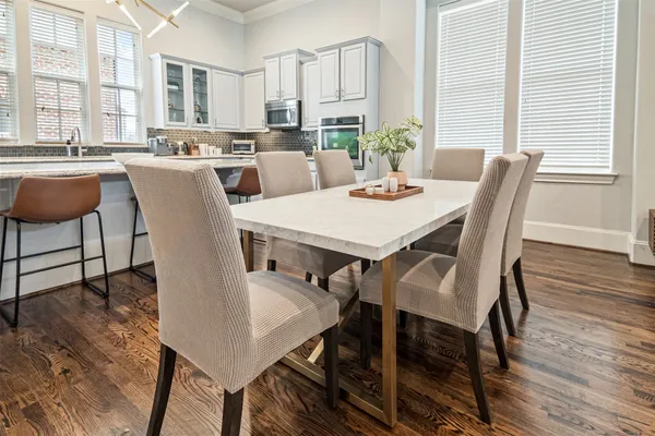 a view of a dining room with furniture window and wooden floor