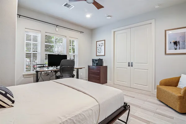 a bedroom with a bed and a couch