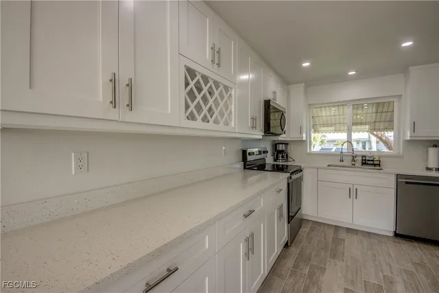 a kitchen with a stove microwave and sink