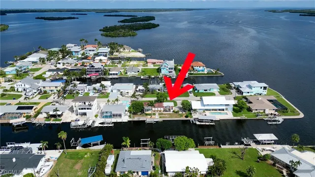 an aerial view of a house with swimming pool and outdoor seating