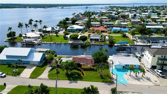 an aerial view of a house with a swimming pool yard and outdoor seating