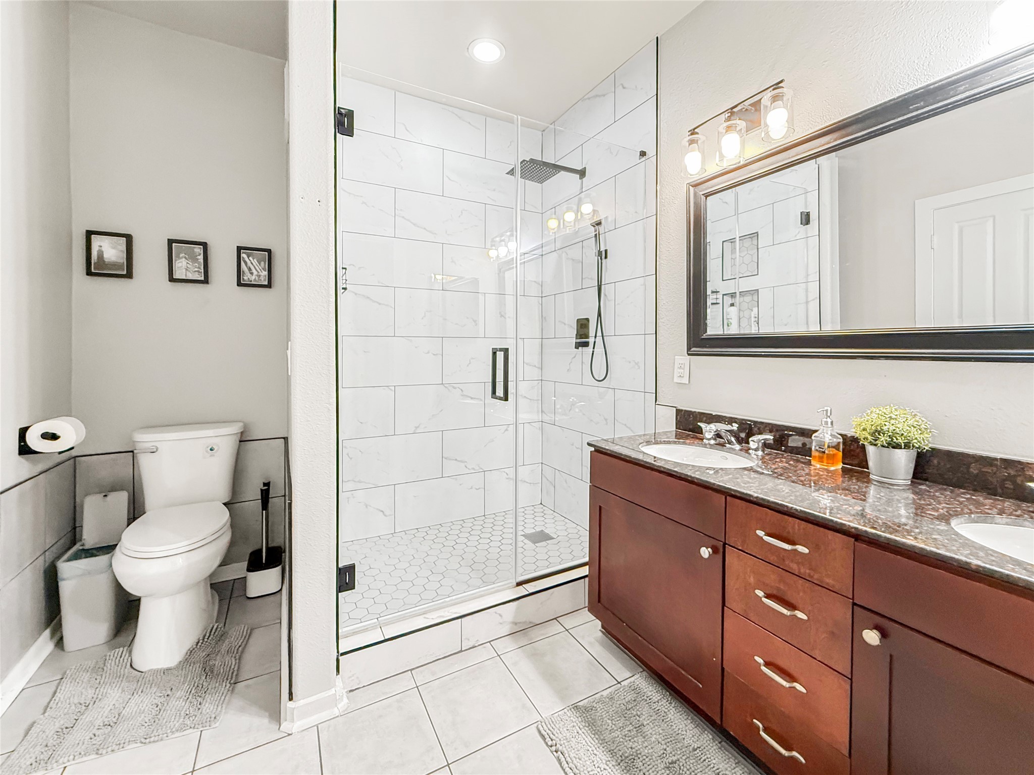 2216 Chenevert Street, Unit 4 Houston, TX 77003 - Photo 19 of 23 a bathroom with a granite countertop toilet sink and shower