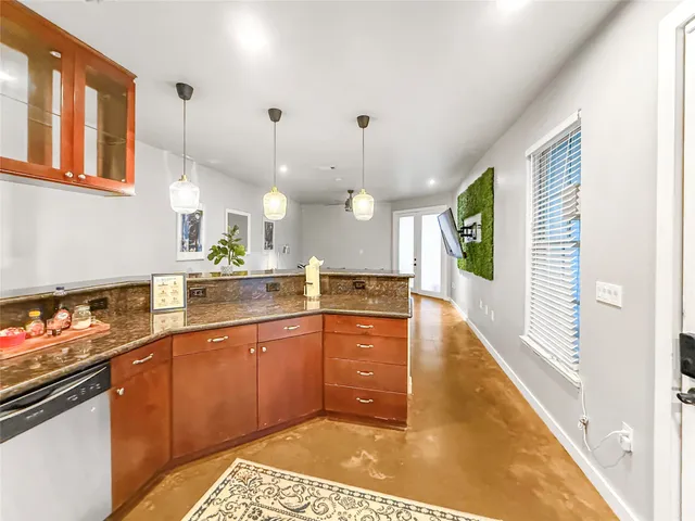 a large kitchen with kitchen island a sink stainless steel appliances and cabinets