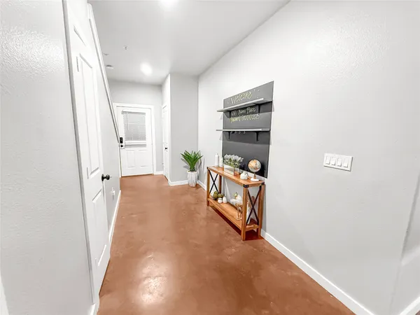 a view of a hallway to a livingroom and a couch
