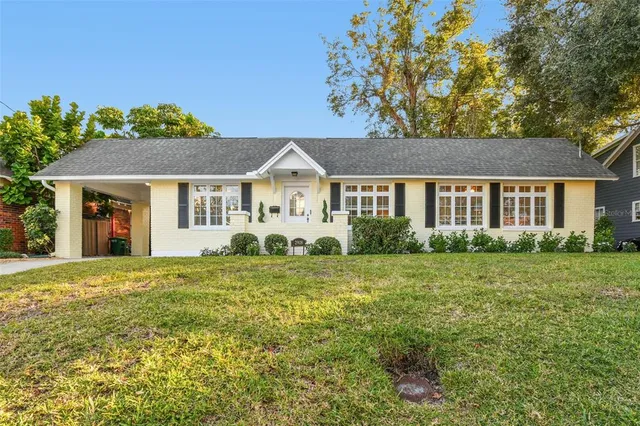 a front view of a house with a garden