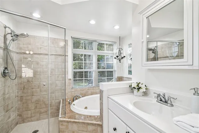 a bathroom with a sink tub shower and mirror