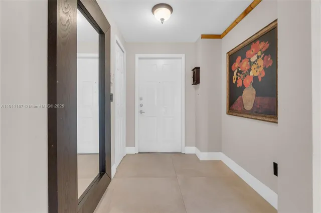 a view of a hallway with wooden floor and closet