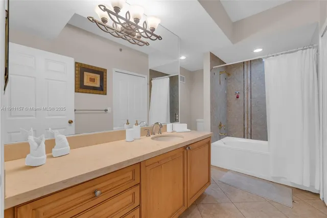a bathroom with a sink a large mirror and a bathtub