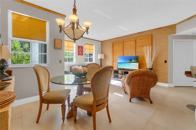 a view of a dining room with furniture and a window