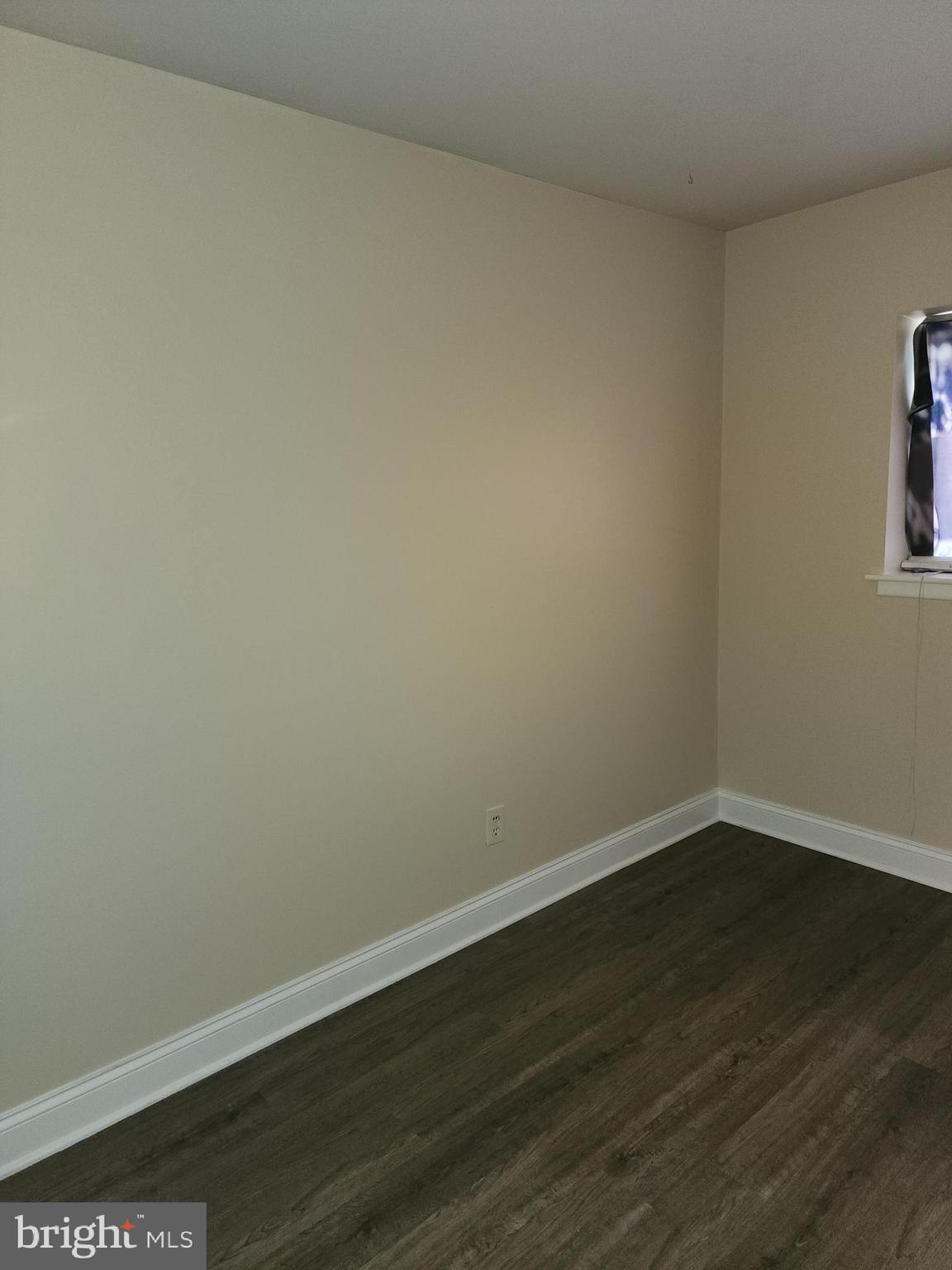 8030-00 Ditman Street, Unit 146Z Philadelphia, PA 19136 - Photo 24 of 41 a view of an empty room with wooden floor and a window