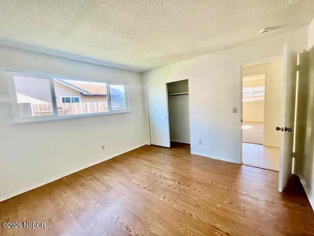 1012 West Anthony Way Lompoc, CA 93436 - Photo 22 of 38 an empty room with wooden floor and windows