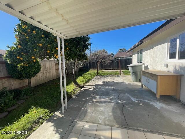 1012 West Anthony Way Lompoc, CA 93436 - Photo 31 of 38 a view of a patio with table and chairs potted plants with wooden fence