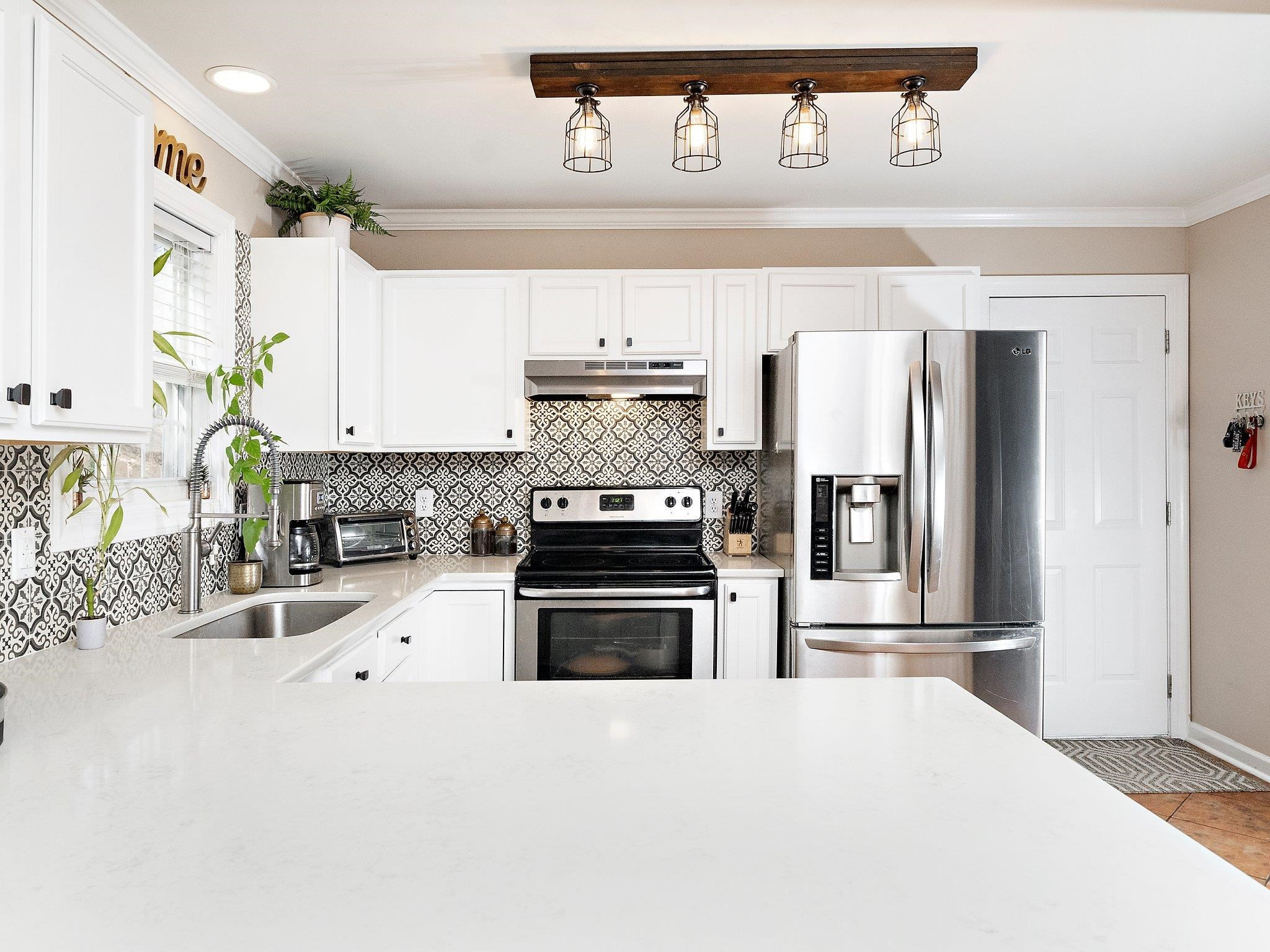 8312 Hobhouse Circle Raleigh, NC 27615 - Photo 12 of 39 a kitchen with granite countertop a refrigerator and a stove top oven